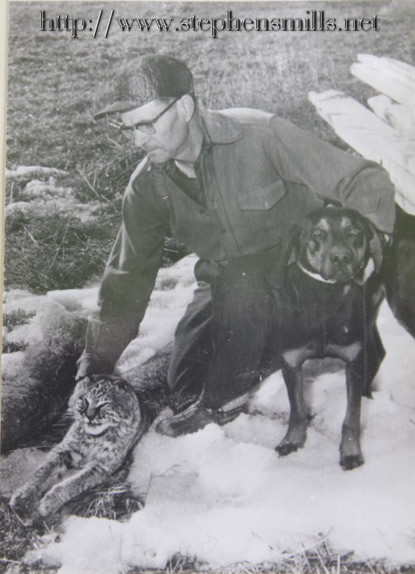 Photo of Alfred Jackson with his hunting dog and bobcats