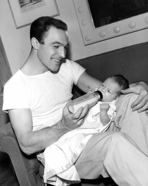 Gene Kelly bottle feeding his daughter Kerry 1942 