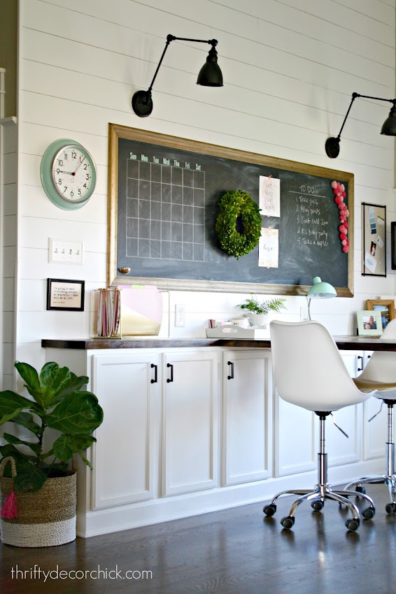 office space with large desk and chalkboard