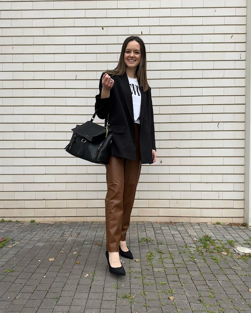 woman in t-shirt, blazer and faux leather pants