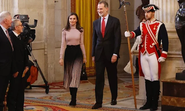 Queen Letizia wore a Marlie contrast pleat midi skirt by Reiss, and pink cashmere sweater. Latouche suede boots. Mauska bag