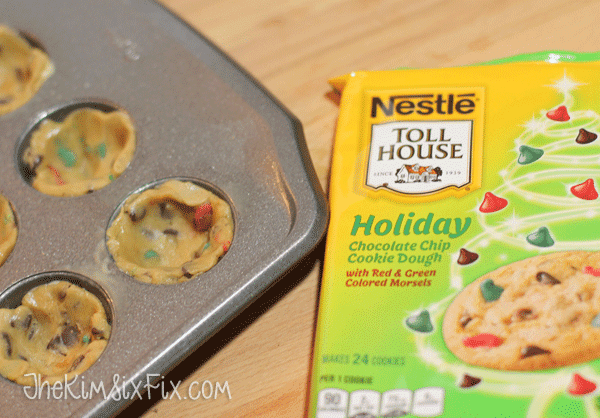 Pressing cookie dough into pan for cups