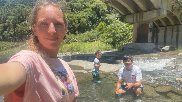 Polish girl, Taiwanese guy and son playing in the water