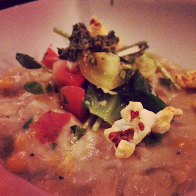 Jumbo Lump Crab and Potato Goat Cheese Gnocchi tossed in a Louisiana Sweet Corn, Sherry, and Parmesan-Truffle Sauce topped with Collard Green Pesto and a Micro Salad of Brussels Sprouts, Tiny Basil, Heirloom Tomatoes and Cajun Spiced Popcorn.