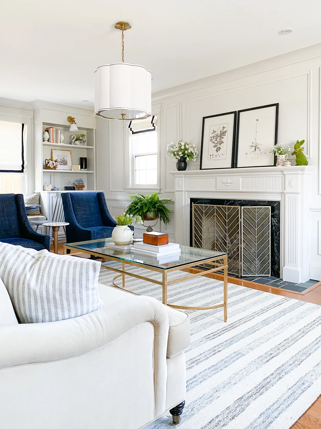 traditional living room layout with sofa and two accent chairs and fireplace