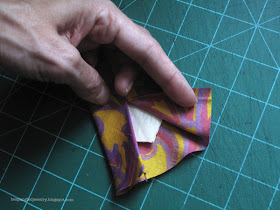 Step 2: Fold back the outer layer of fabric and cut the lining into a point