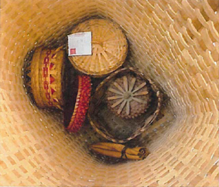 A mix of contemporary decorative baskets sitting inside a large, berry-picking basket. A small tied bundle of tobacco-a sacred medicine that cleanses, comforts, and offers protection-accompanies the baskets. Image courtesy of Dr. John N. Low.