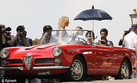  model and actress Lin Chiling poses in the vintage red Alfa Romeo
