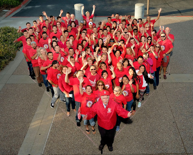 People in red forming a heart - aerial view - Mr. T at the point of the heart