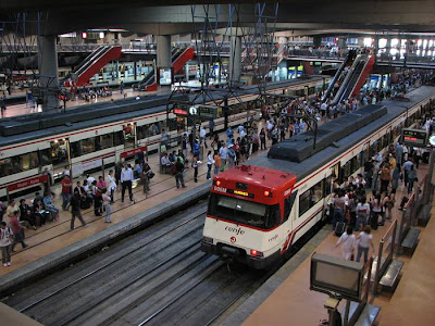 Madrid Atocha (Spanish: Estación de Madrid Atocha, also named Madrid Puerta de Atocha) is the largest railway station in Madrid. It is the primary station serving commuter trains (Cercanías), intercity and regional trains from the south, and the AVE high speed trains from Barcelona (Catalonia), Saragosse (Aragon), Seville (Andalusia) and Valencia (Levante Region). These train services are run by the Spanish national rail company, Renfe. The station is in the Atocha neighborhood of the district of Arganzuela. The original façade faces the Plaza del Emperador Carlos V, a site at which a variety of streets converge, including the Calle de Atocha, Paseo del Prado, Paseo de la Infanta Isabel, Avenida de la Ciudad de Barcelona, Calle de Méndez Álvaro, Paseo de las Delicias, Paseo de Santa María de la Cabeza, and Ronda de Atocha.