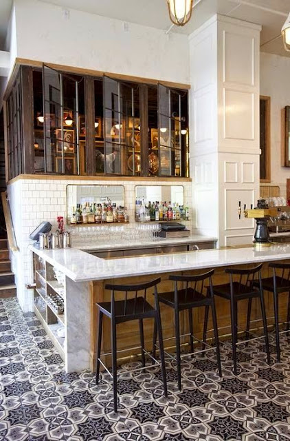 cool bar area patterned tile floor glass cabinets