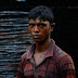 A worker at an informal market for car parts in Dhaka
