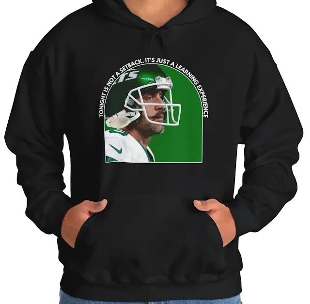 A Hoodie With NFL Player Aaron Wearing Green Helmet and Quote Tonight is Not a Setback It's Just