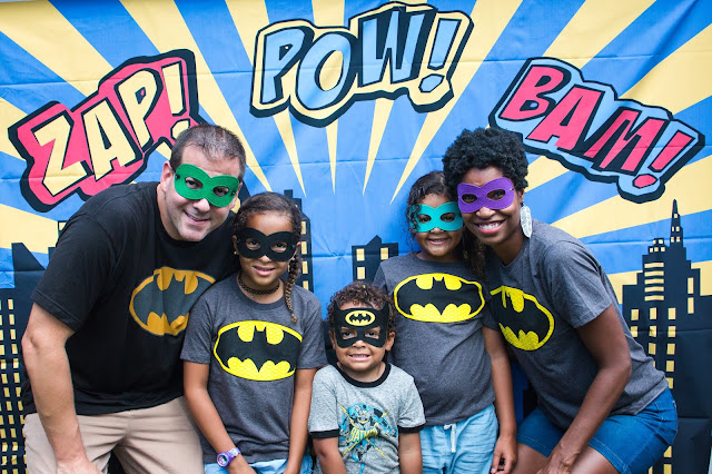 Photo backdrop and batman t-shirts at a batman party