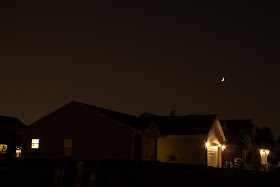 crescent moon over neighborhood