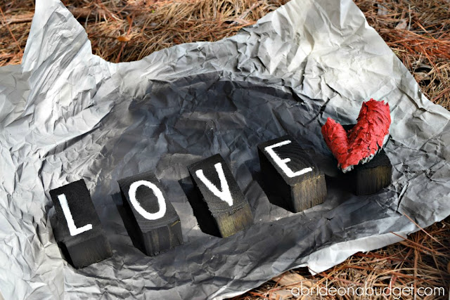 Wedding signs are SO popular! But you don't have to buy them all. You can make your own. Find out how to make this DIY LOVE sign at www.abrideonabudget.com.