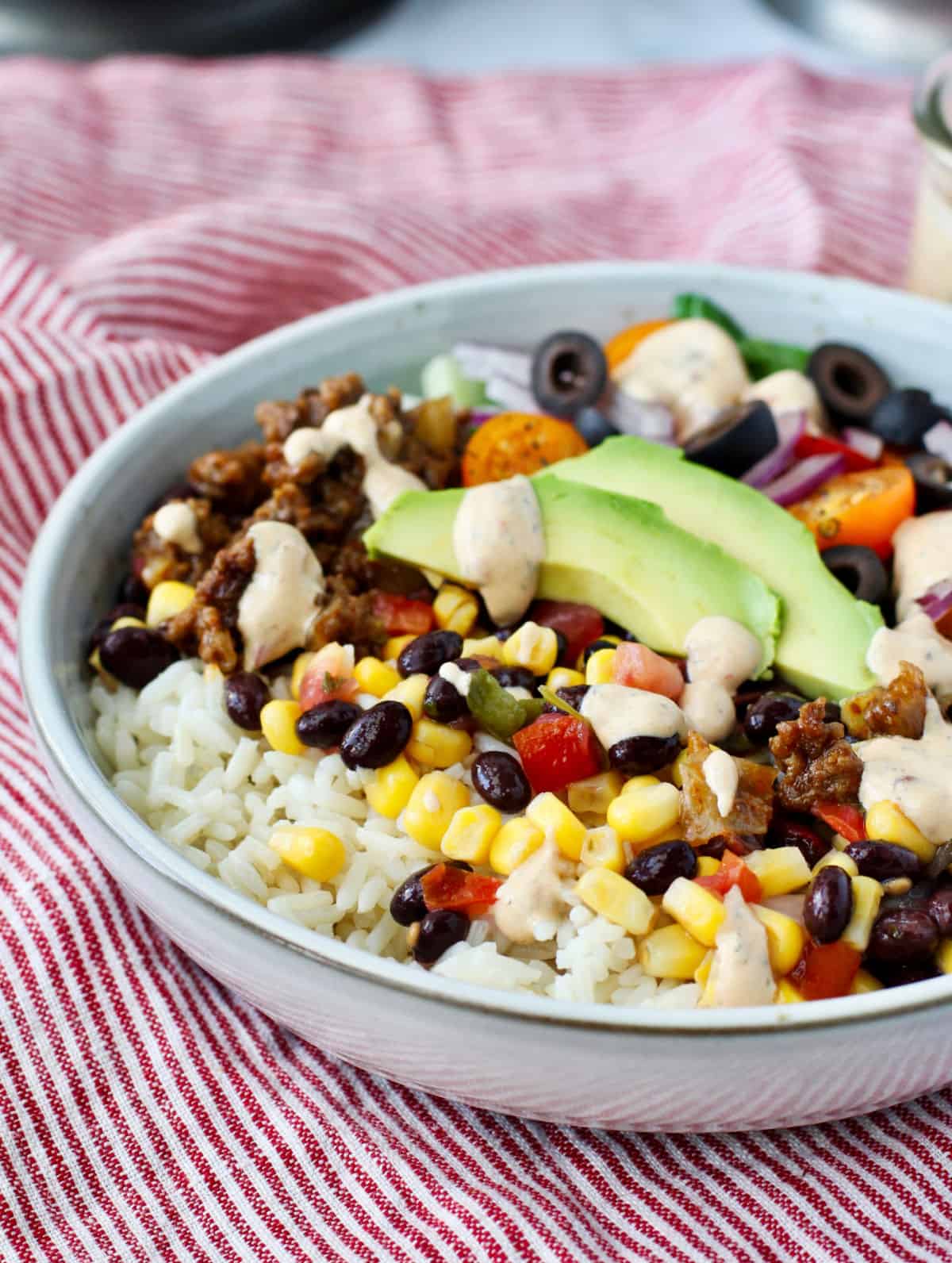 Burrito Bowls with Corn and Tomatoes plus veggies in a bowl.