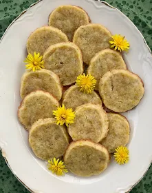 Finished cookies on a large platter with flowers.