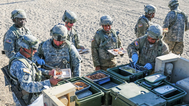 Researchers from USU will soon look at how best to promote healthy food choices in the military. Here, soldiers of Headquarters Company, 155th Armored Brigade Combat Team, Mississippi Army National Guard, serve hot chow in the field at the National Training Center. (Photo credit: Mississippi National Guard Staff Sgt. Veronica McNabb, 102d Public Affairs Detachment)
