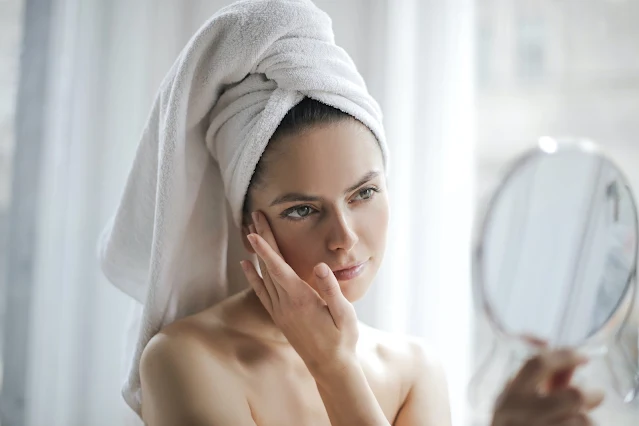 Woman scrubing face