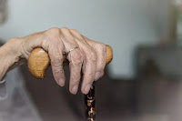 old mother's hand holding her stick