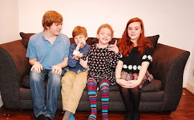 picture of Theo, Jules, Daisy and Xanthe sat together on the sofa