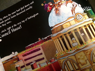 Inside the book showing santas sleigh on the council house roof