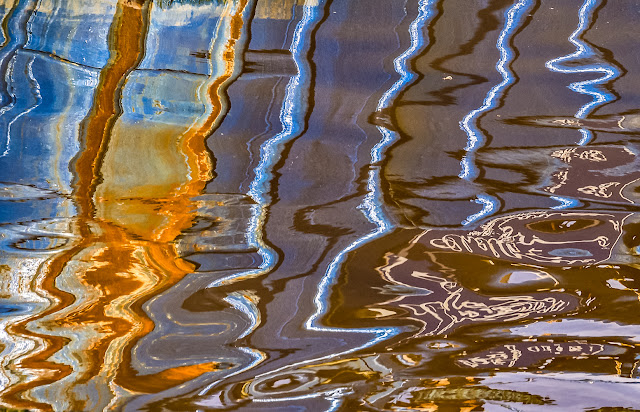 Photo of fishing boat reflections