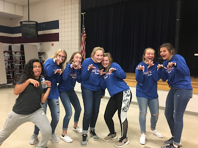 A group of teen girls posing like zombies