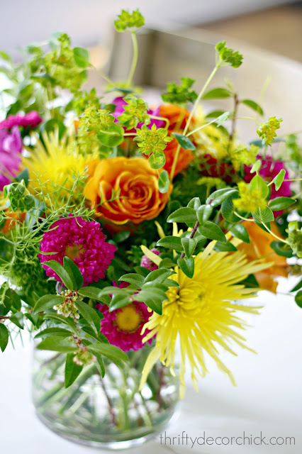 Bright floral arrangement with roses, mums and asters
