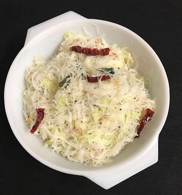 Bee hoon, curry leaves, mustard seeds, dried red chillies, and cabbage stir fried.