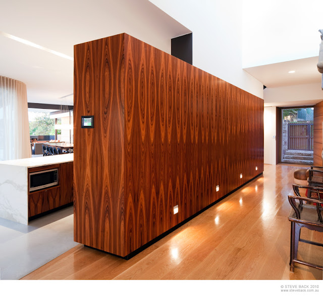 Wooden kitchen wall in the River House by MCK Architects