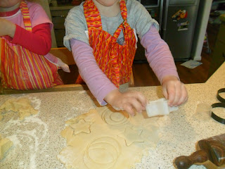 Child cutting out biscuits in a kid friendly recipe.