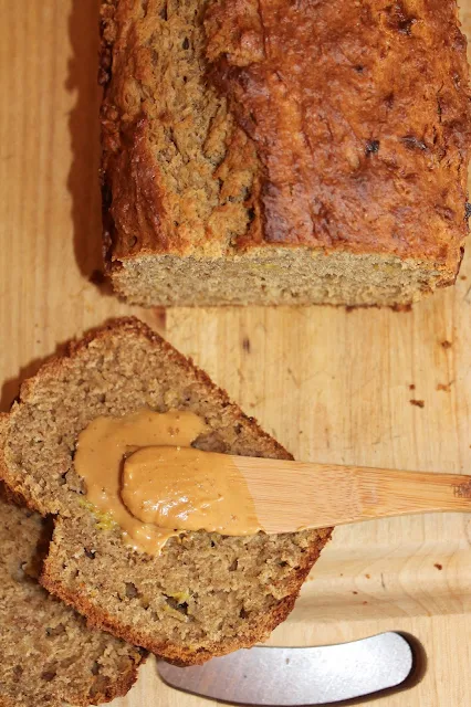 Slice of peanut butter banana bread with peanut butter spread on top.