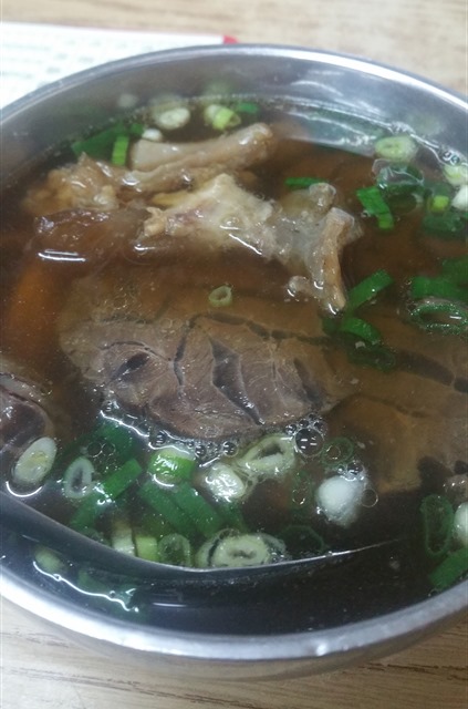 Lin Dong Fang Beef Noodles served in steel bowl.