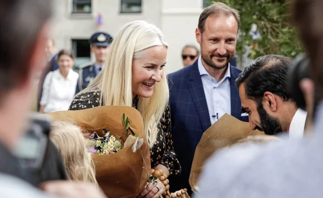 Crown Princess Mette-Marit wore a Japanese dots satin midi dress from by TiMo. Crown Prince Haakon. Hammersborg youth club