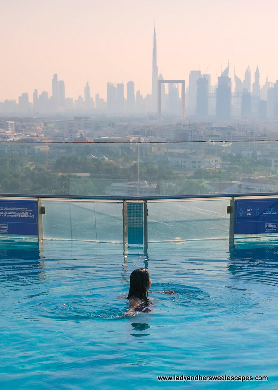 Lady in Hilton Dubai Creek Hotel rooftop pool