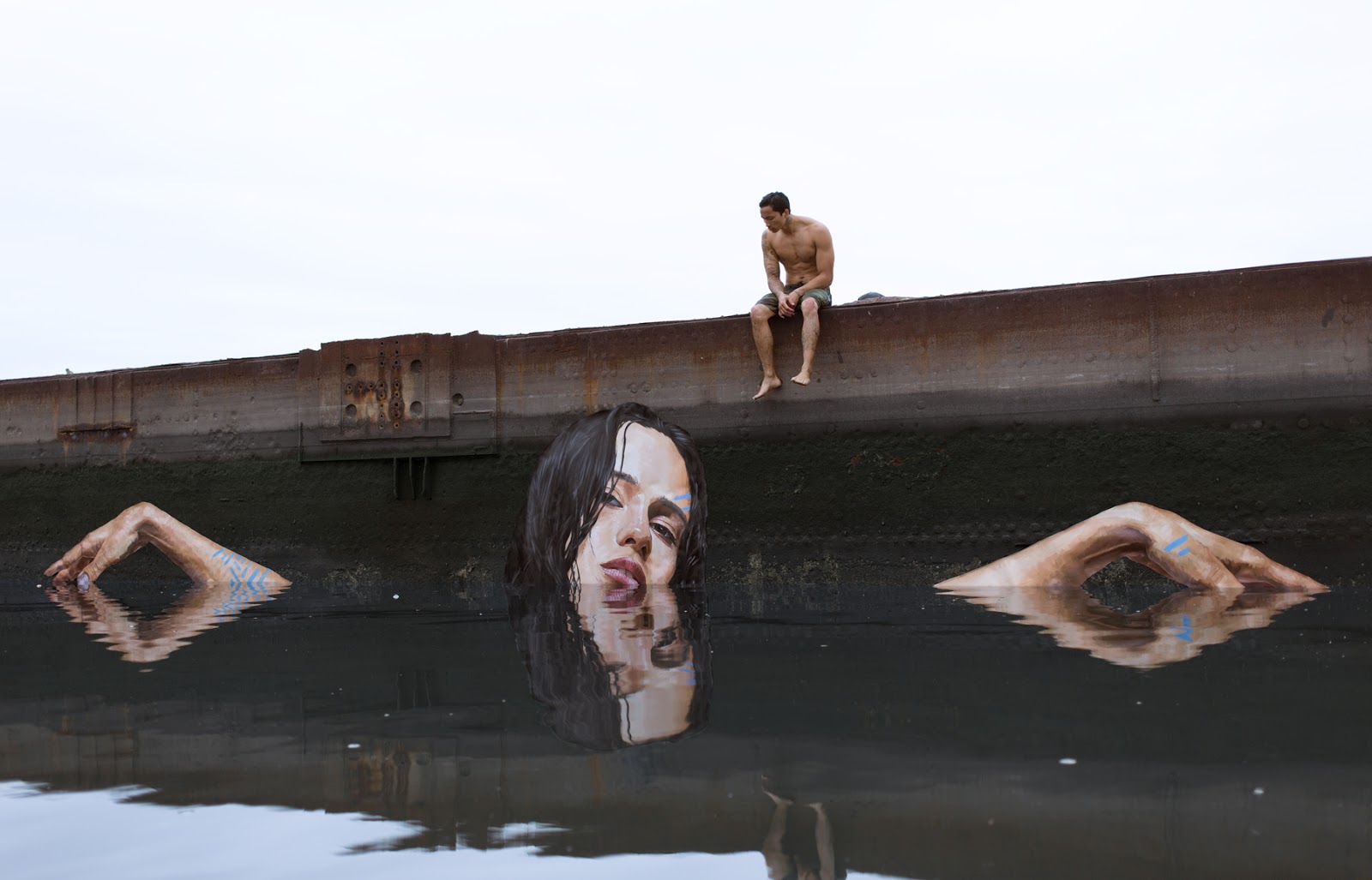 Artist Paints Murals of Women While Floating on a Surfboard