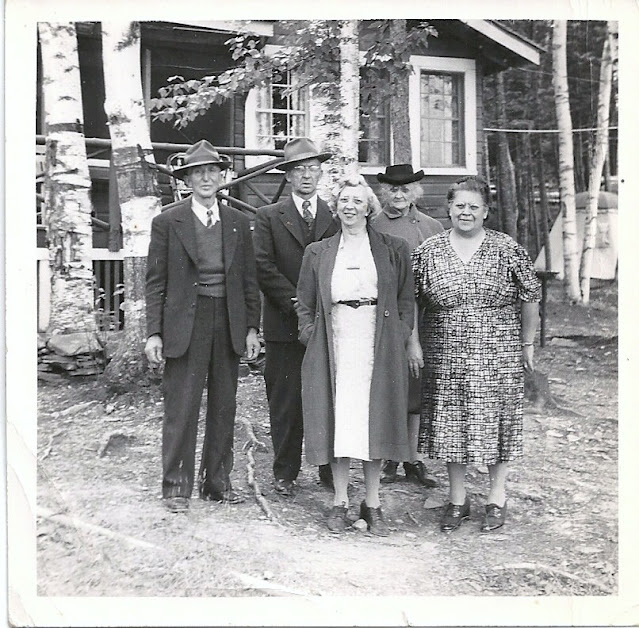 Photo of Walter Carpenter, Frank Carpenter, Cora, Florence, and Vie at the camp on Drew's Lake, Maine