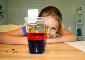 Tessa observed that oil, water and corn syrup have different densities. Before dropping small objects of various weights into the cup, she guessed where each would stay and then recorded the actual results. This was quite entertaining.