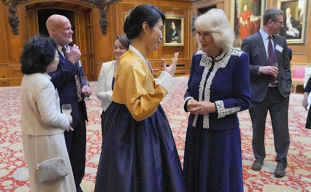 Queen Camilla wore a new lace-adorned jacket by Fiona Clare. Kiki McDonough Apollo mini blue topaz and diamond pendant