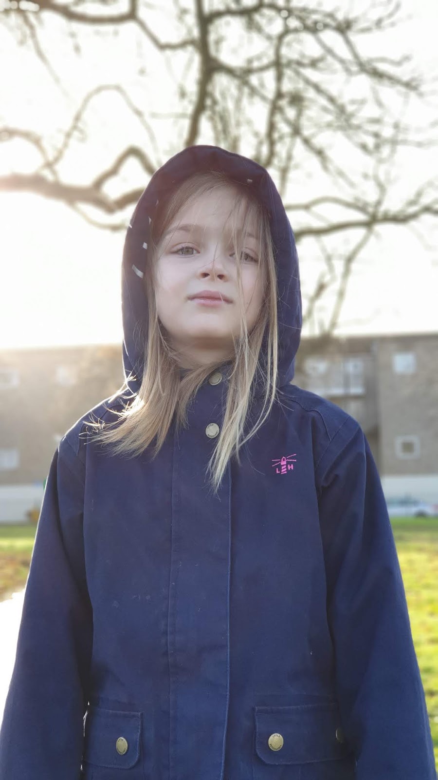 girl in a navy lighthouse clothing emma coat