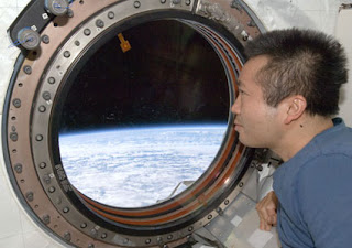 Expedition 19 Flight Engineer Koichi Wakata looks through a window in the Kibo laboratory of the International Space Station.