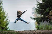 Happy lady jumping over the horizon