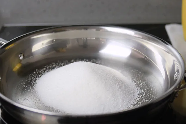 Add sugar to a pan.