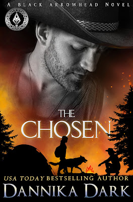Handsome man in a black cowboy hat gazing downward. Bottom of cover is a silhouette of a tent, trees, a woman walking alongside a wolf, and a man kneeling at a campfire. Color scheme is fiery orange and yellow.