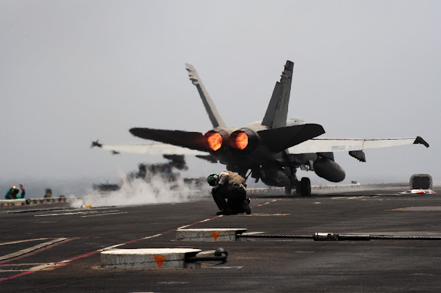 An F/A-18C Hornet from the Rampagers of Strike Fighter Squadron (VFA) 83 launches from the flight deck with full afterburners