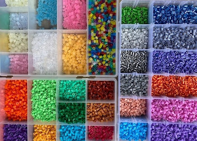 Hama beads sorted by colour in storage containers