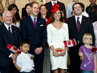 William and Kate, the Duke and Duchess of Cambridge, flanked by Governor General David Johnston, left, and Immigration Minister Jason Kenney smile during a group photo with newly sworn-in Canadians at a citizenship ceremony Friday, July 1, 2011 in Gatineau, Canada.