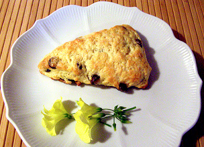 Single scone on plate with flower